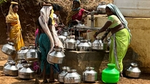 Women filling up water carriers at taps