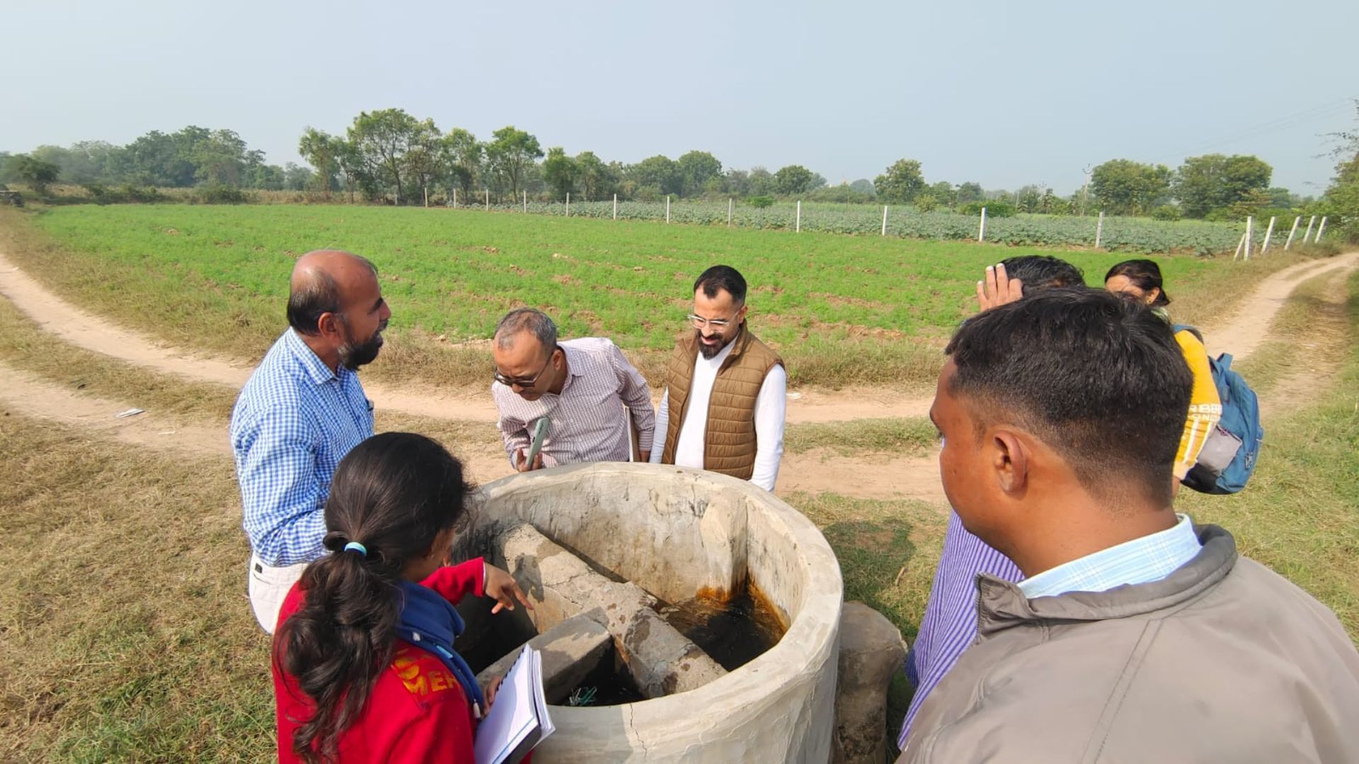 Team of partner, farmers and HUF inspecting a well