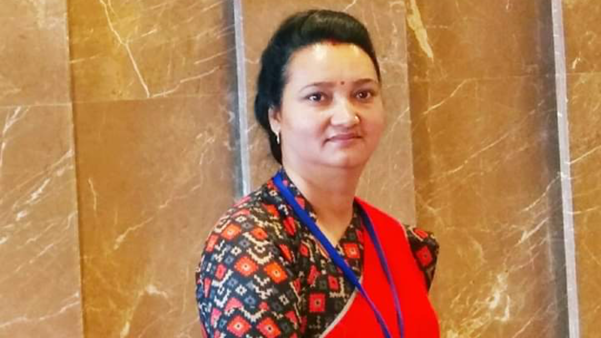 Woman stood in front of marble wall